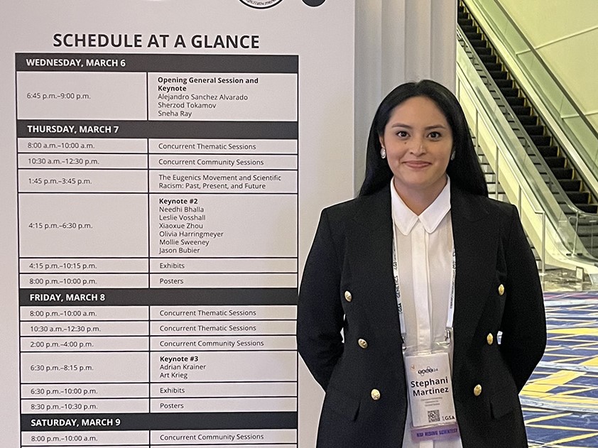Stephani Martinez-Barrera standing in front of the TAGC24 schedule