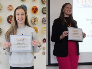 Sarah McKay and Jessica Aycock holding their Bauer Family Travel Award Certificates