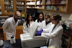 Alexis Stamatikos with students in the lab