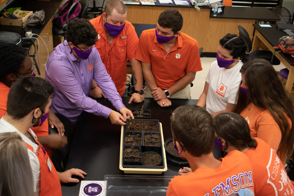 students learning about soil from profesor